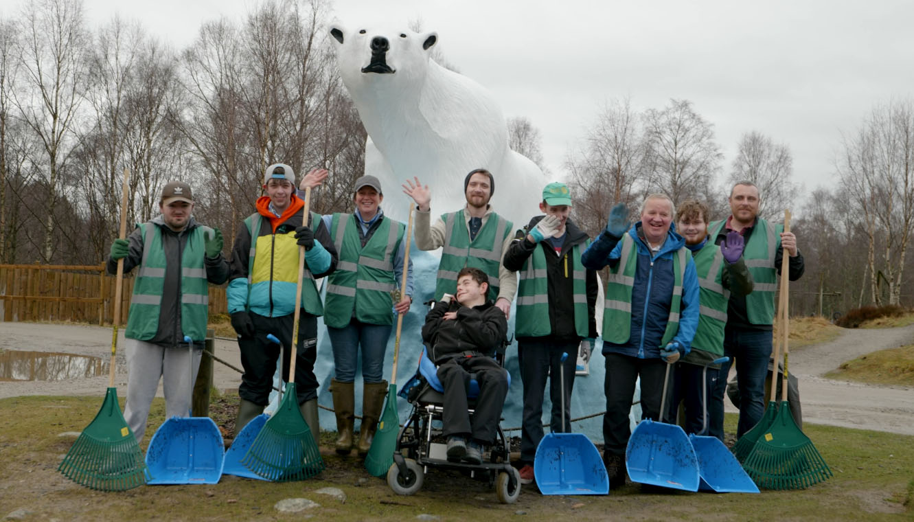 Wildlife Wombles group poses and wave in front of polar bear statue in car park IMAGE: FoSho 2023
